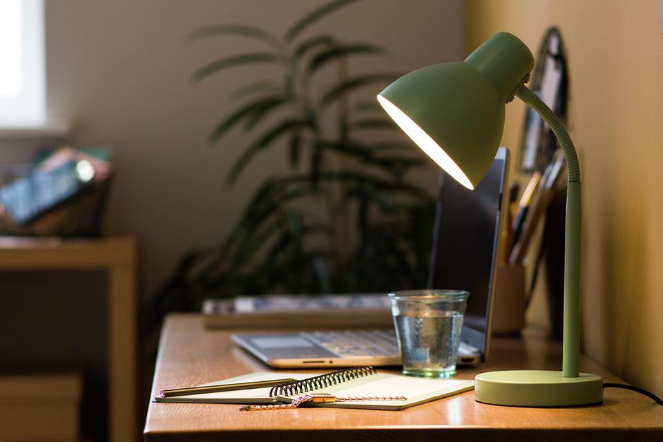 Chargeable desk lamp in brushed chrome on a dark background.