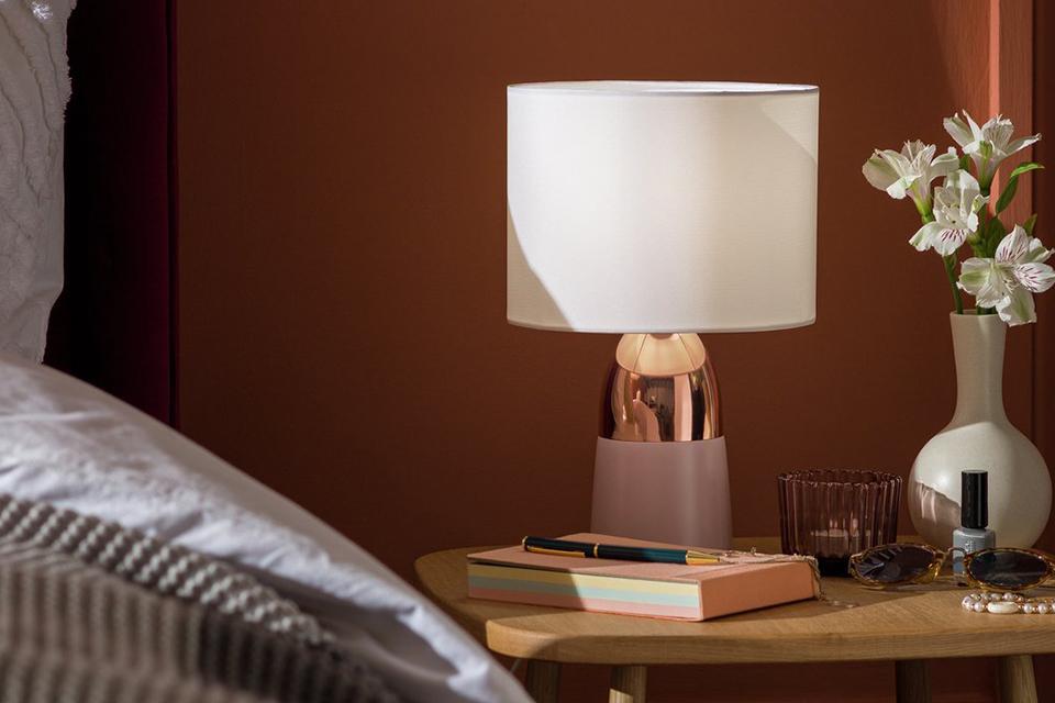 Mustard and chrome touch table lamp next to a green ornament.