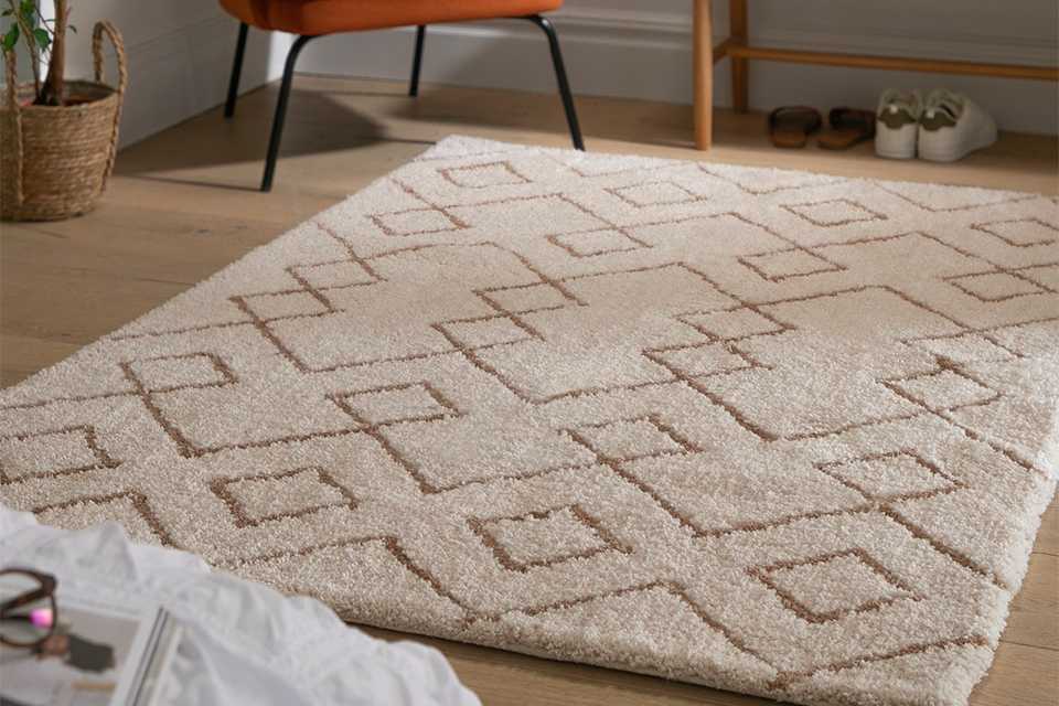 Cream tufted rug with diamond pattern.