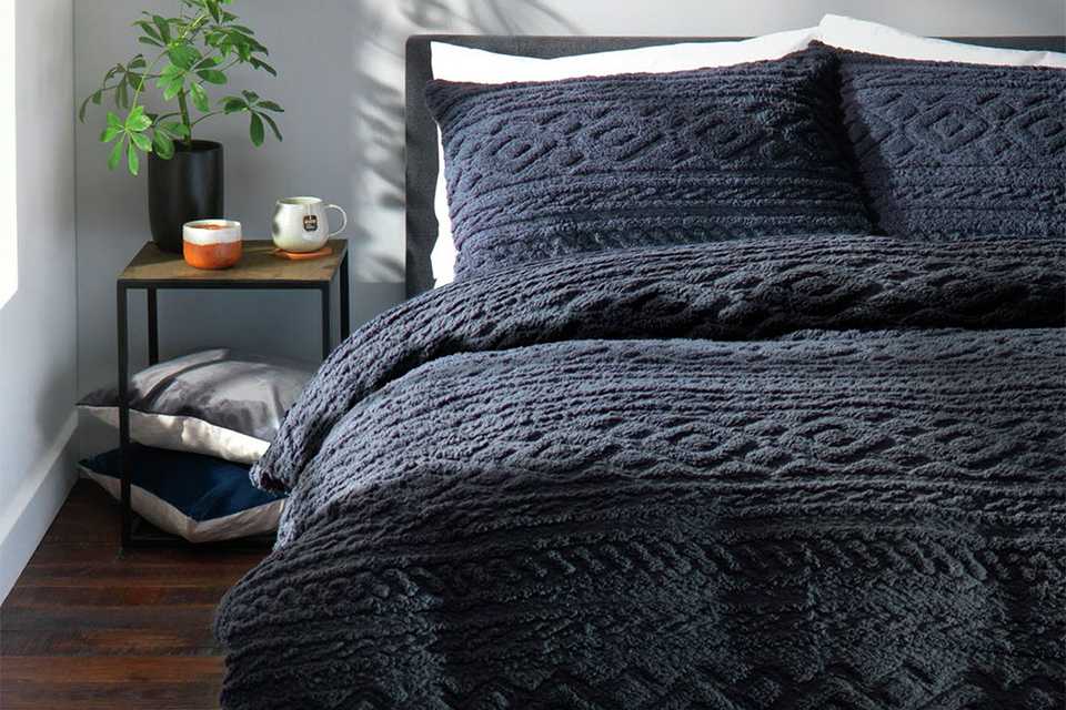 Navy cable knit fleece bedding set.