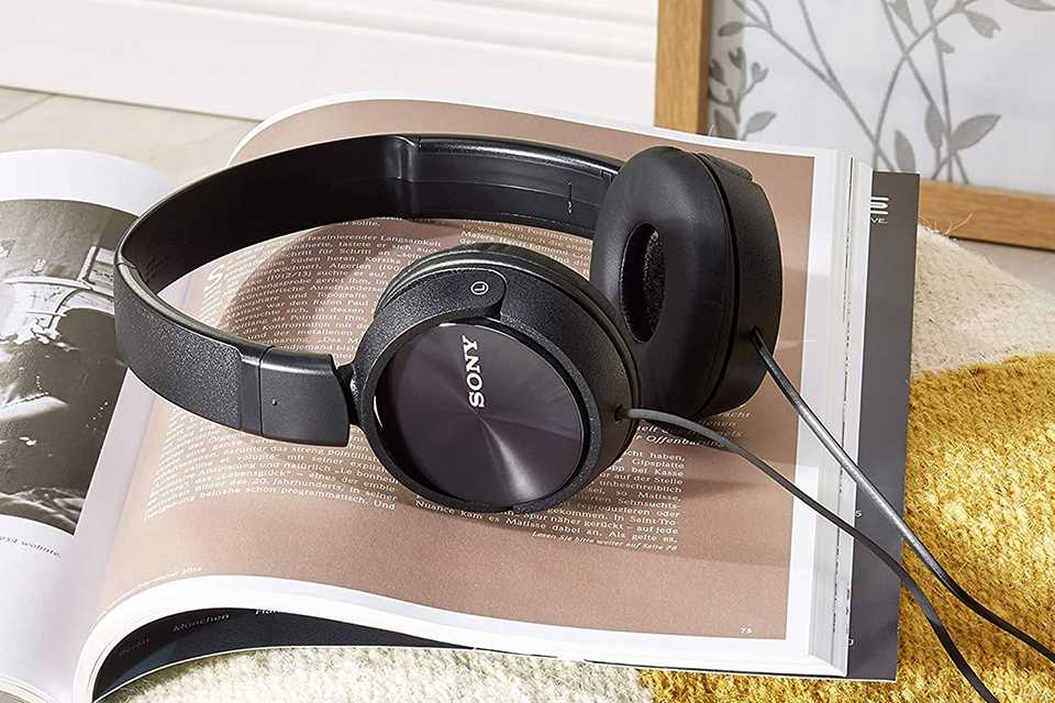 A Sony wired headphone sitting on a magazine.