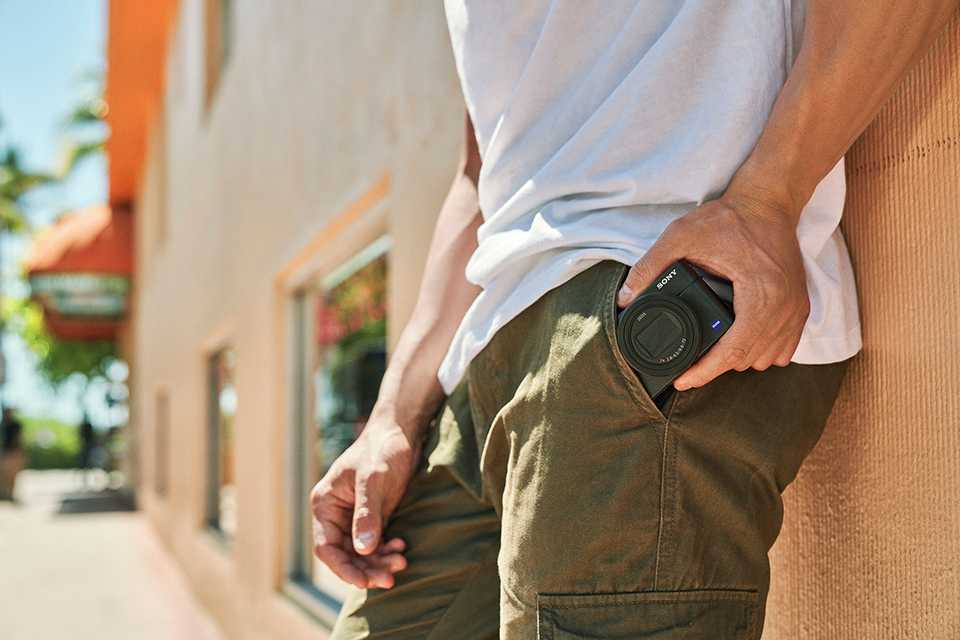 A man taking out a Sony camera from his pocket.