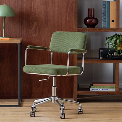 Green office chair on wheels in home office set up.