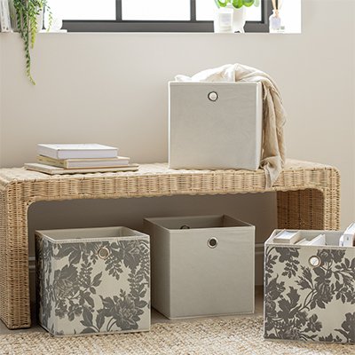 Wicker bedroom bench with box storage in bedroom.