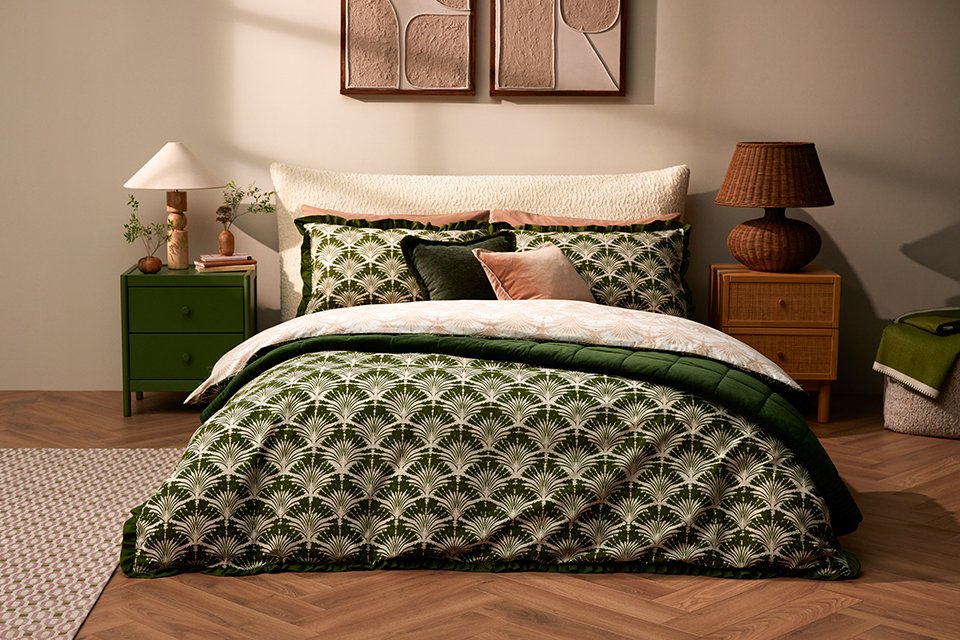 Green patterend Argos bedding on cream bed frame in bedroom. 