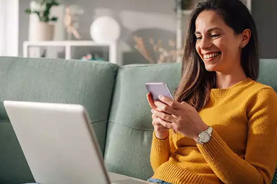 Woman paying for argos order on phone.