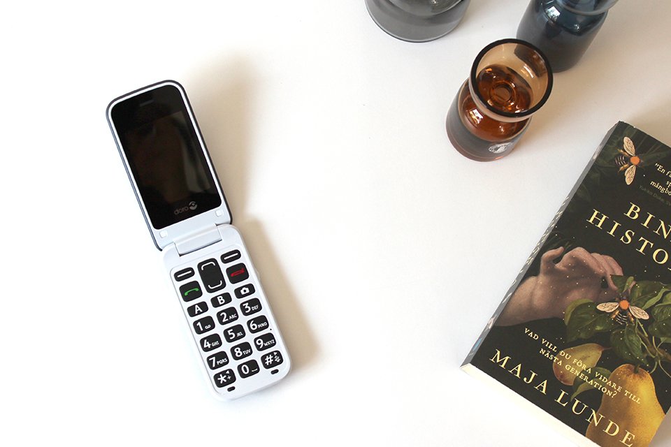 Doro 2424 placed on a tabletop with other things. 