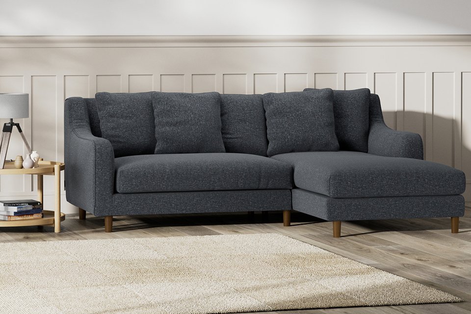 Dark grey corner sofa in neutral living room.