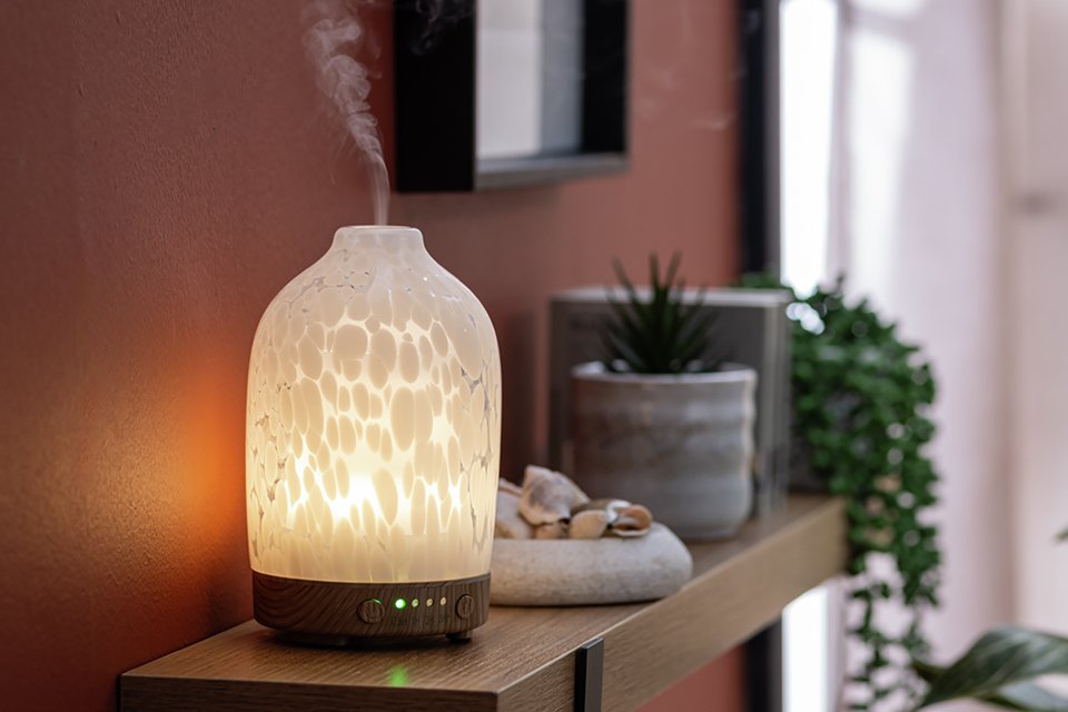 Glass white room difuser in living room.