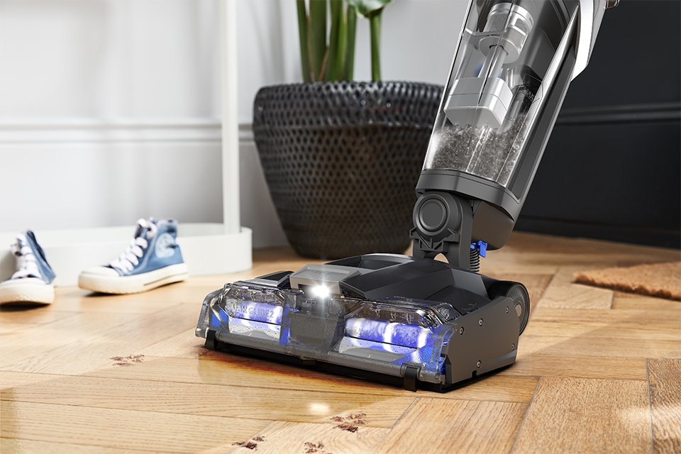 A close up shot of Vax vacuum cleaner on a wooden floor.