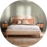 Green bedroom with cream boucle bed in bedroom.