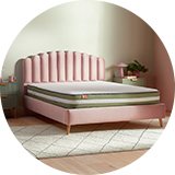 Pink headboard with mattress.