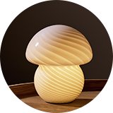 Mushroom glass lamp on sided table.