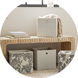 Wicker bedroom bench with box storage in bedroom.