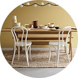 Woven rug under dining room table.