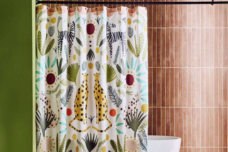 A Habitat Global antibacterial shower curtain in a bathroom.