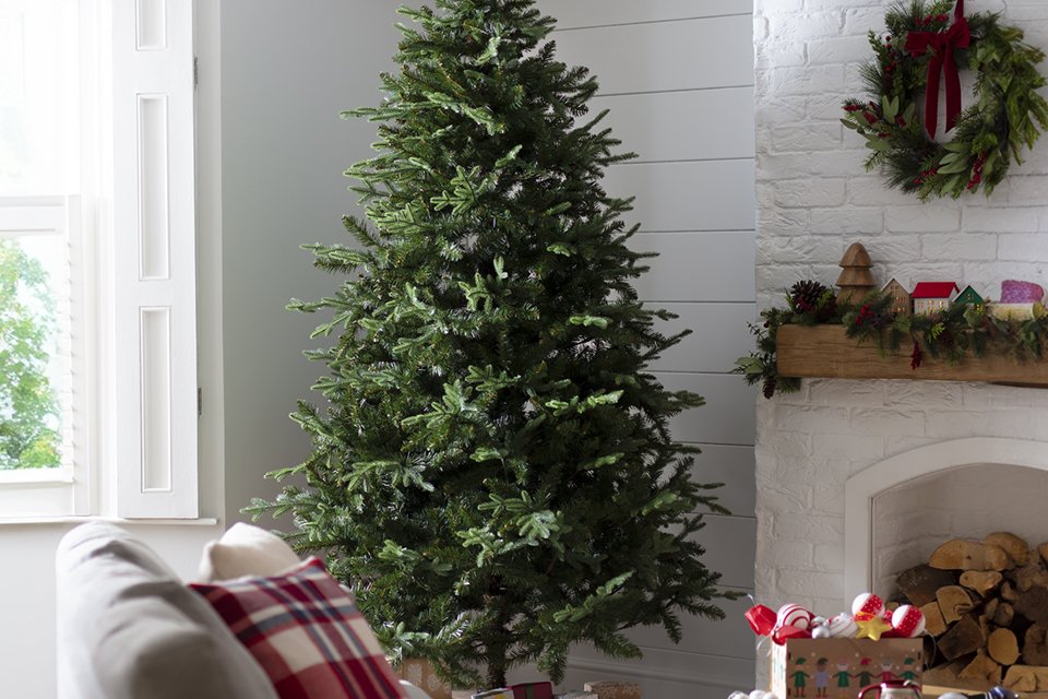 A Habitat 8ft unlit natural look tree in a cosy living room.