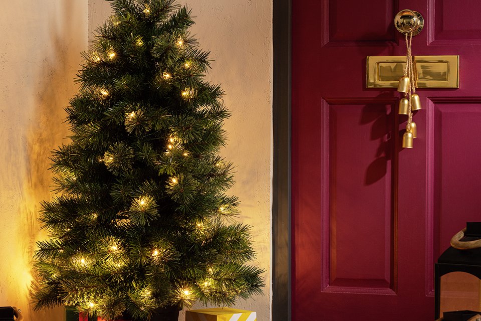 A Habitat 4ft pre-lit small Christmas tree with gifts under it.