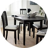 An Argos Home black oval dining table with some chairs.