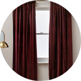 Argos Home velvet curtains placed on a window.