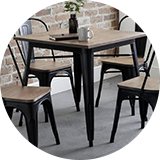 A Julien Bowen Grafton square dining table with some chairs.