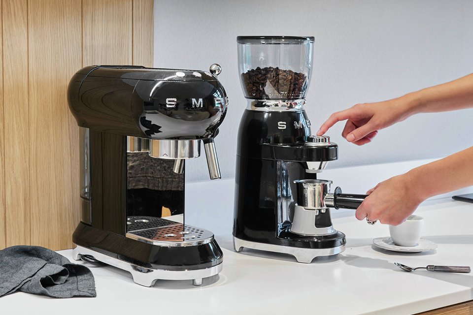 A Smeg 50's style retro coffee bean grinder.