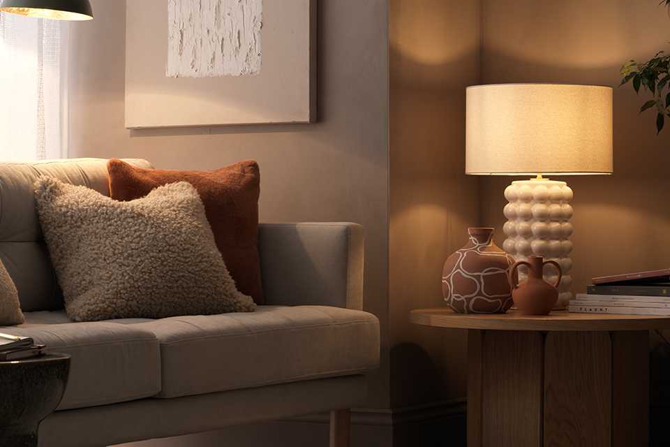 Neutral living room with bubble lamp and sofa.