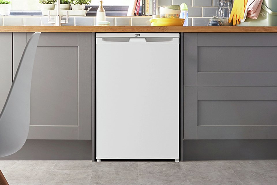 A Beko white under counter freezer in a kitchen setup.