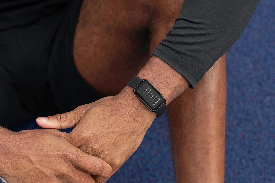 A man wearing a Sekonda black silicone strap fitness tracker and smart watch.