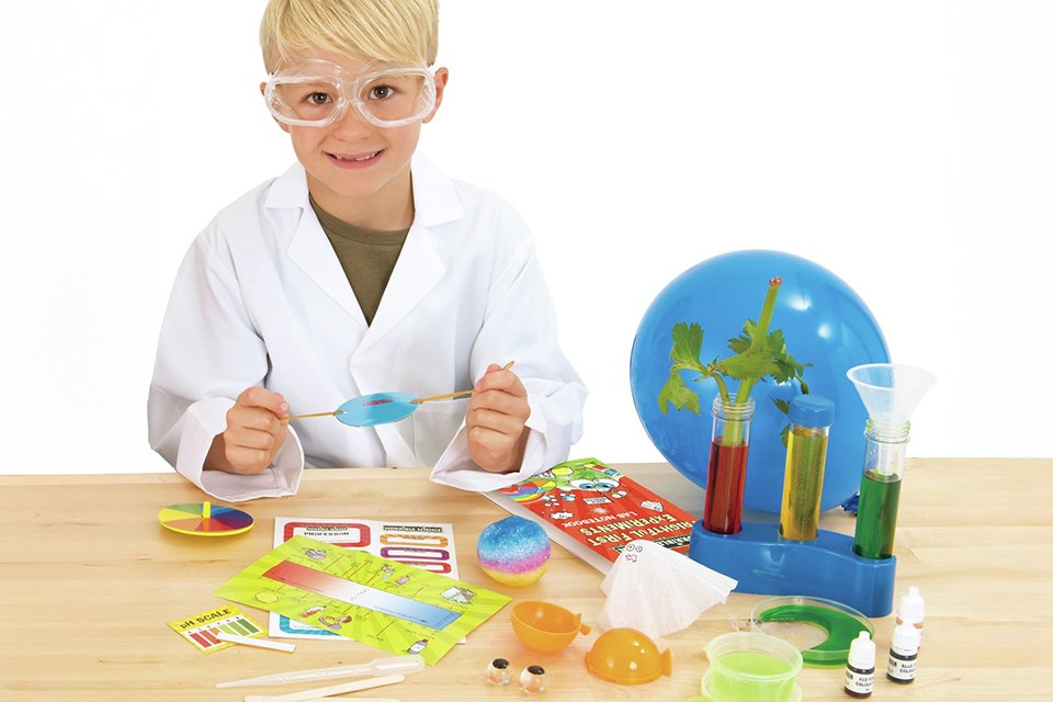 A little boy playing with Horrible Science Frightful First Experiment Kit.
