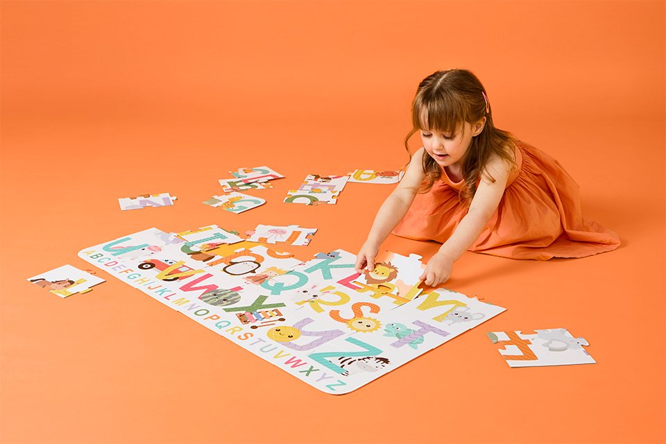 A girl solving a Chad Valley puzzle game.