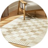 Beige checkerboard design rug in wool and jute on a wooden floor .