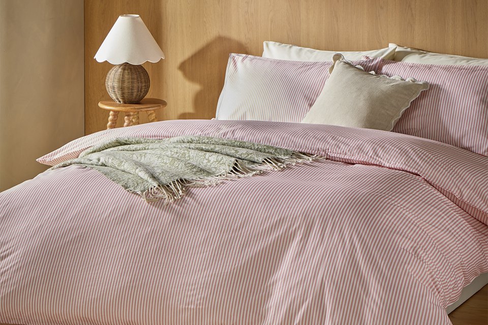 A bed made with a Habitat Oxford striped cotton single bedding set.