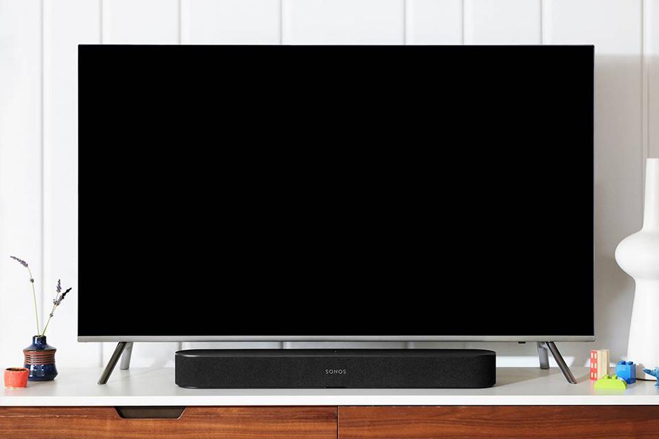A sound bar show underneath a TV.