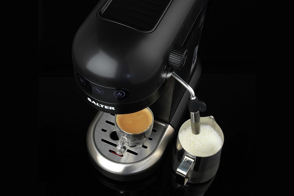 A Salter EK5240BO Espirista espresso coffee machine dispensing coffee and steaming milk.