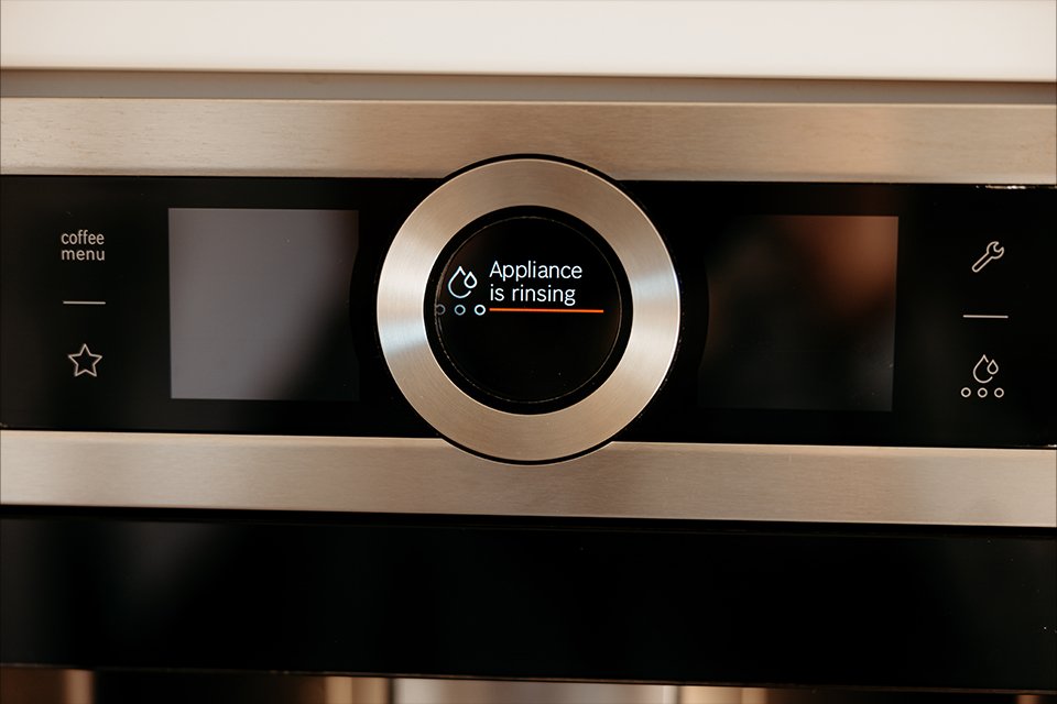 Appliance is rinsing message on a coffee machine.