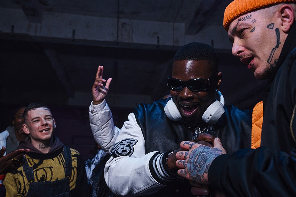 A group of friends enjoying and listening to music while wearing white Sony headphones. 