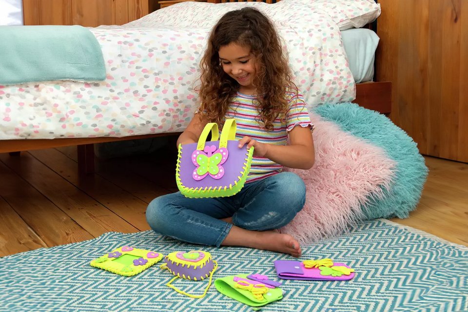 A girl playing with Galt first sewing kit.