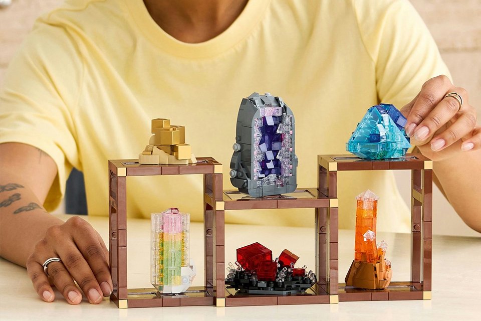 A girl building LEGO Ideas mineral collection building set 21362.