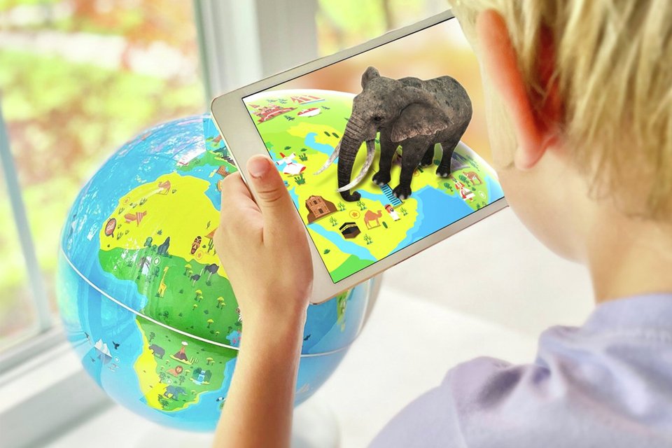 A kid playing with Playshifu Orboot Earth.