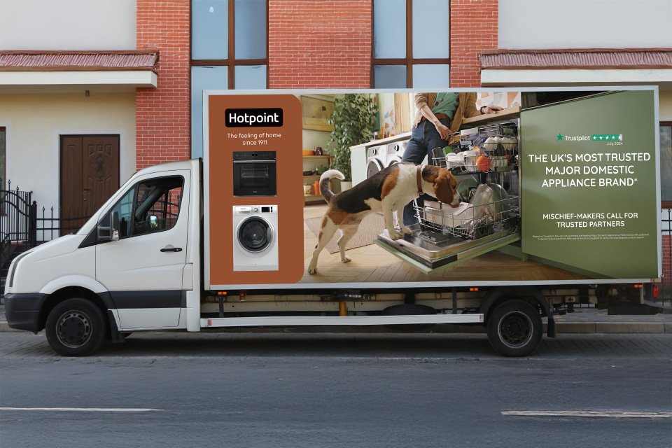 A Hotpoint home delivery van parked on the side of a road showcasing the Hotpoint brand poster.