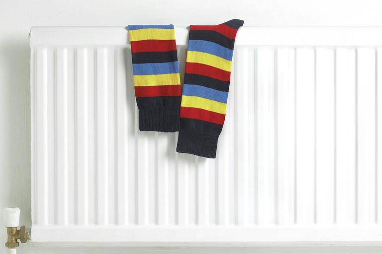 Striped socks on a radiator.