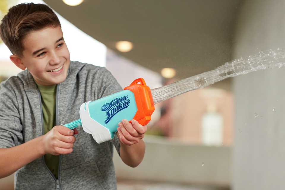 A teen playing with his water gun.