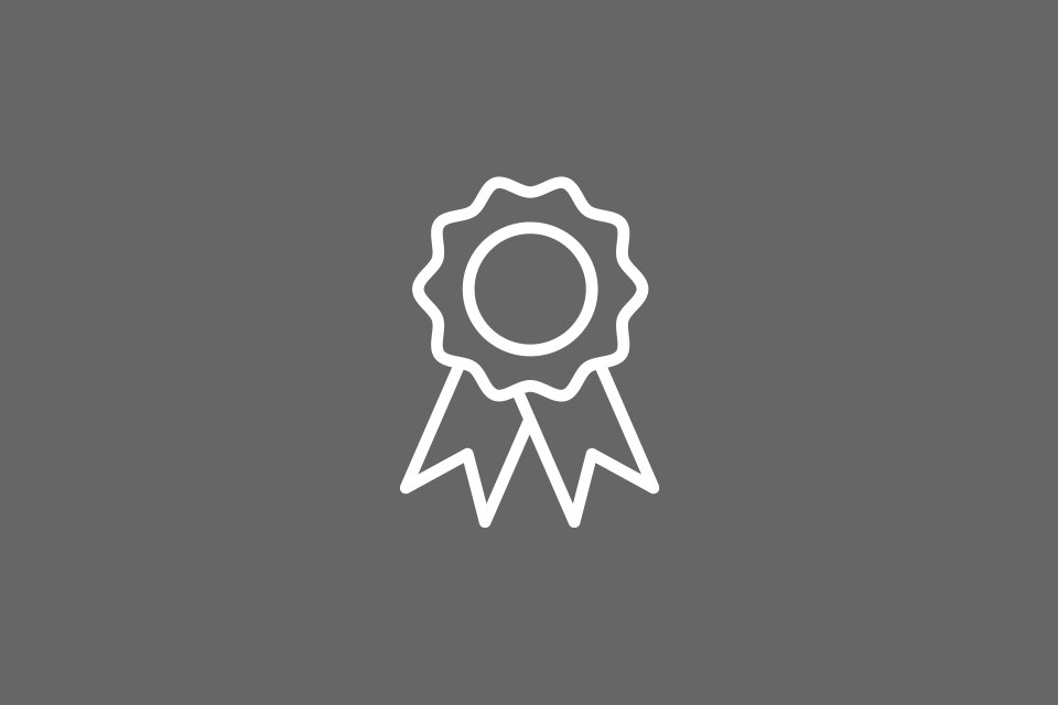 White outline of prize winner rosette on a gray background.