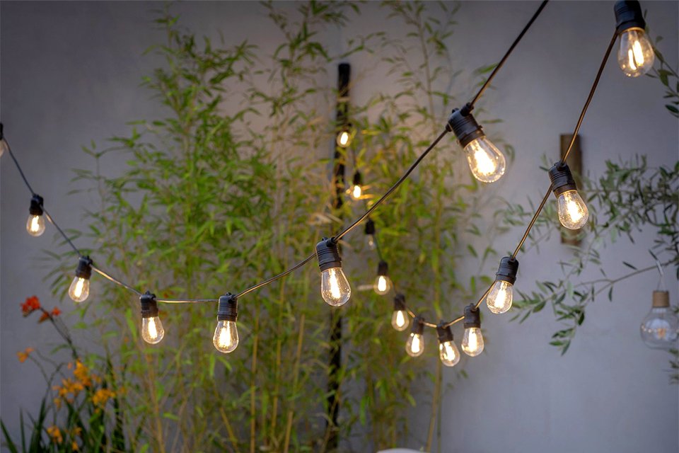 Habitat 30 Warm White Bulb Festoon light hung outdoors on a patio.