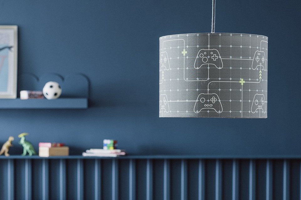 Argos Home Kids Grey Glow in Dark Drum Lampshade in a kid's bedroom with blue coloured walls.