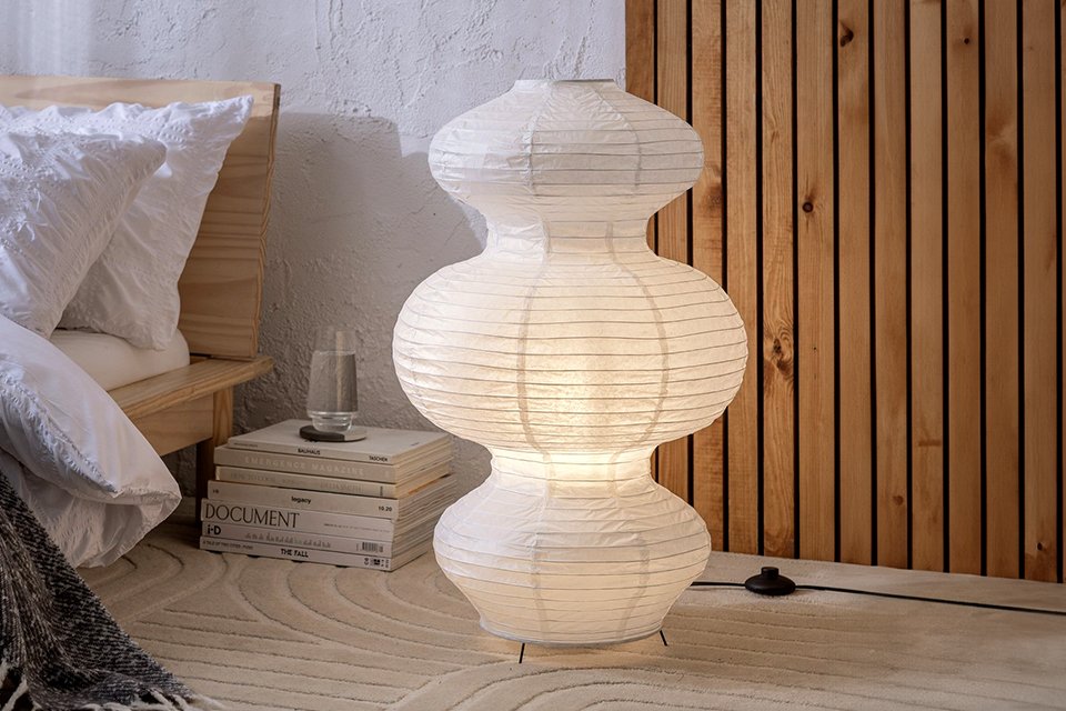 Habitat Sala paper 3 tier floor lamp in white next to a wooden bed with white bedding.