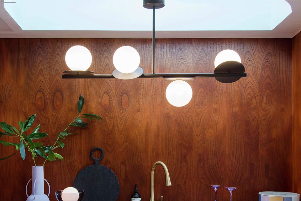 Houseof Opal Disk Metal Bathroom Ceiling Light in charcoal finish hung in a kitchen with wooden finish walls.