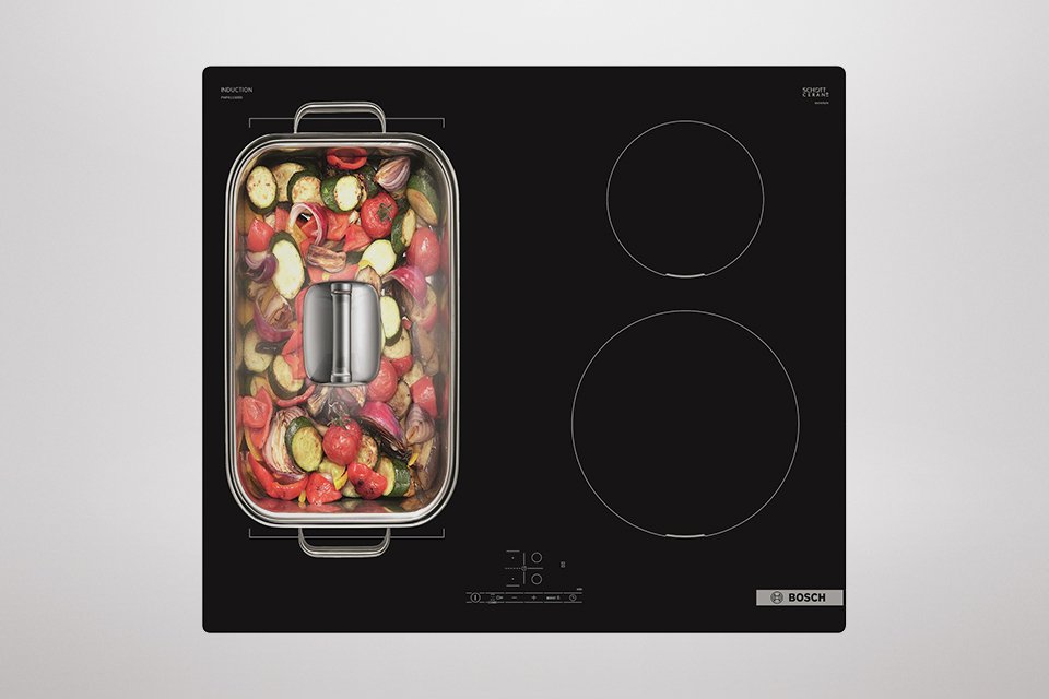 A large pan of food on a hob.