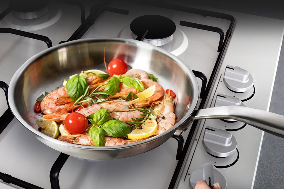 Veggies and seafood cooking on Hisense GM642XHS Gas hob.
